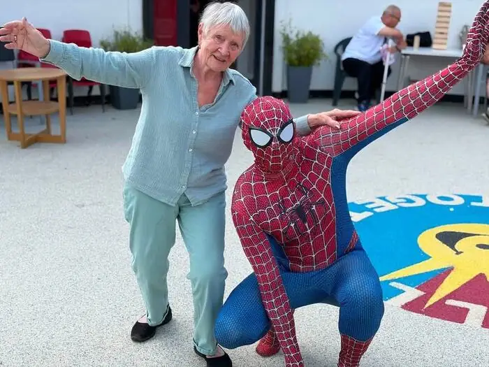 Spider-Man posing with a guest at a charity event