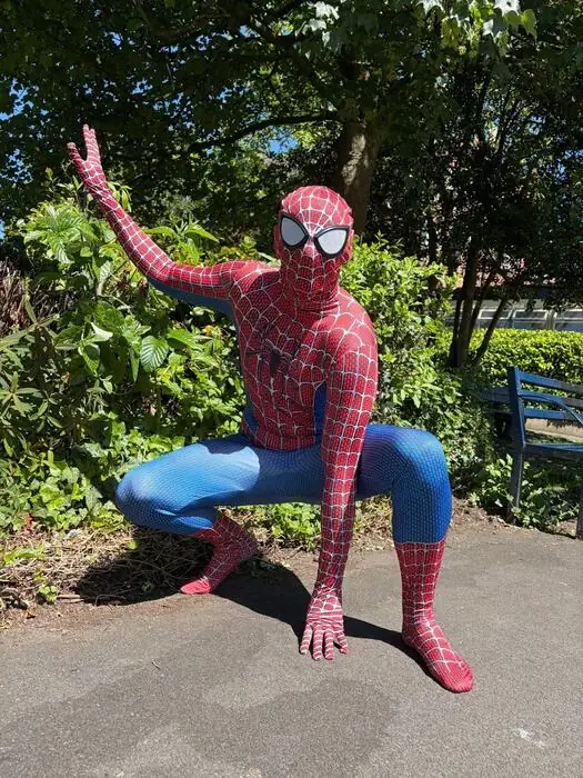 Spider-Man crouching in a garden, ready for action